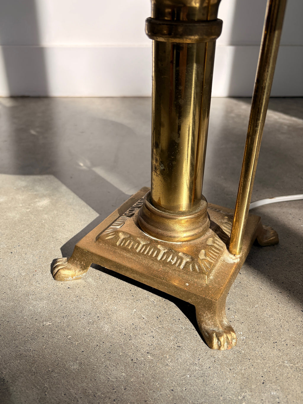 Close up of ornate brass claw feet base detail