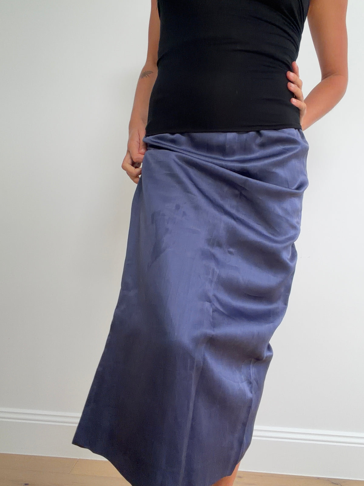 Front view of blue Emilia Wickstead skirt worn with a black top