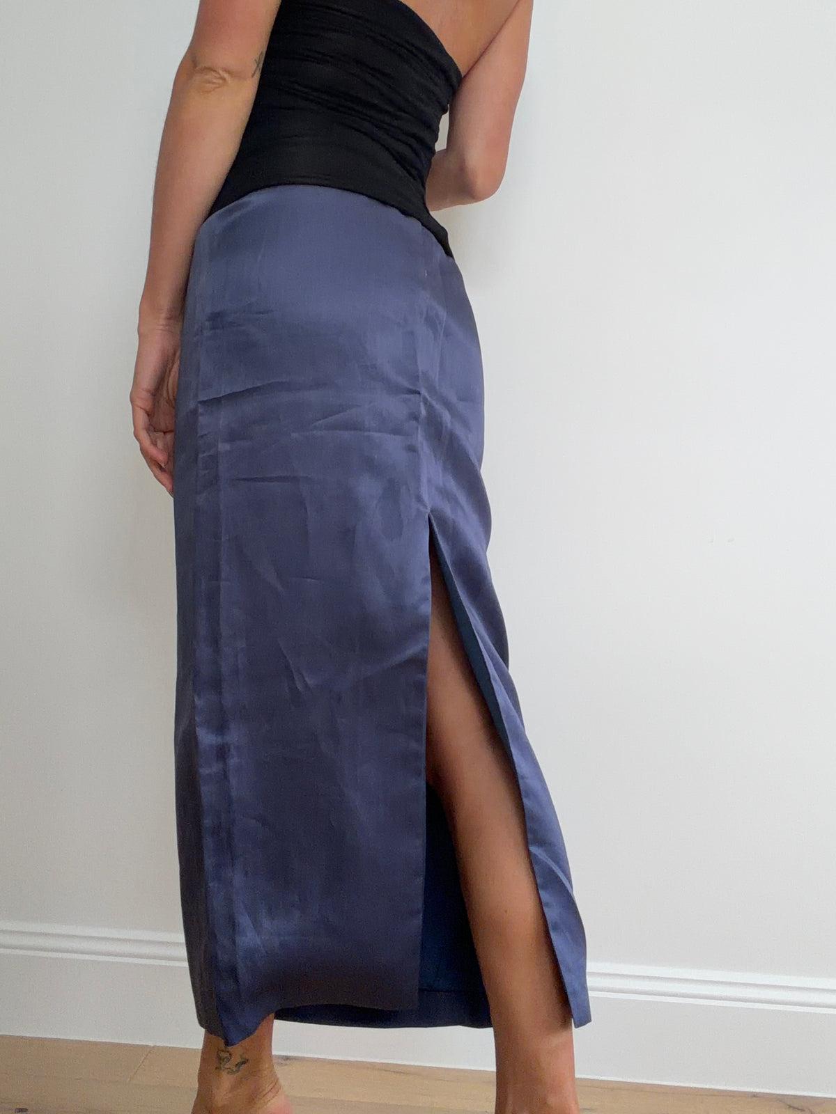 Rear view of blue skirt showing back slit