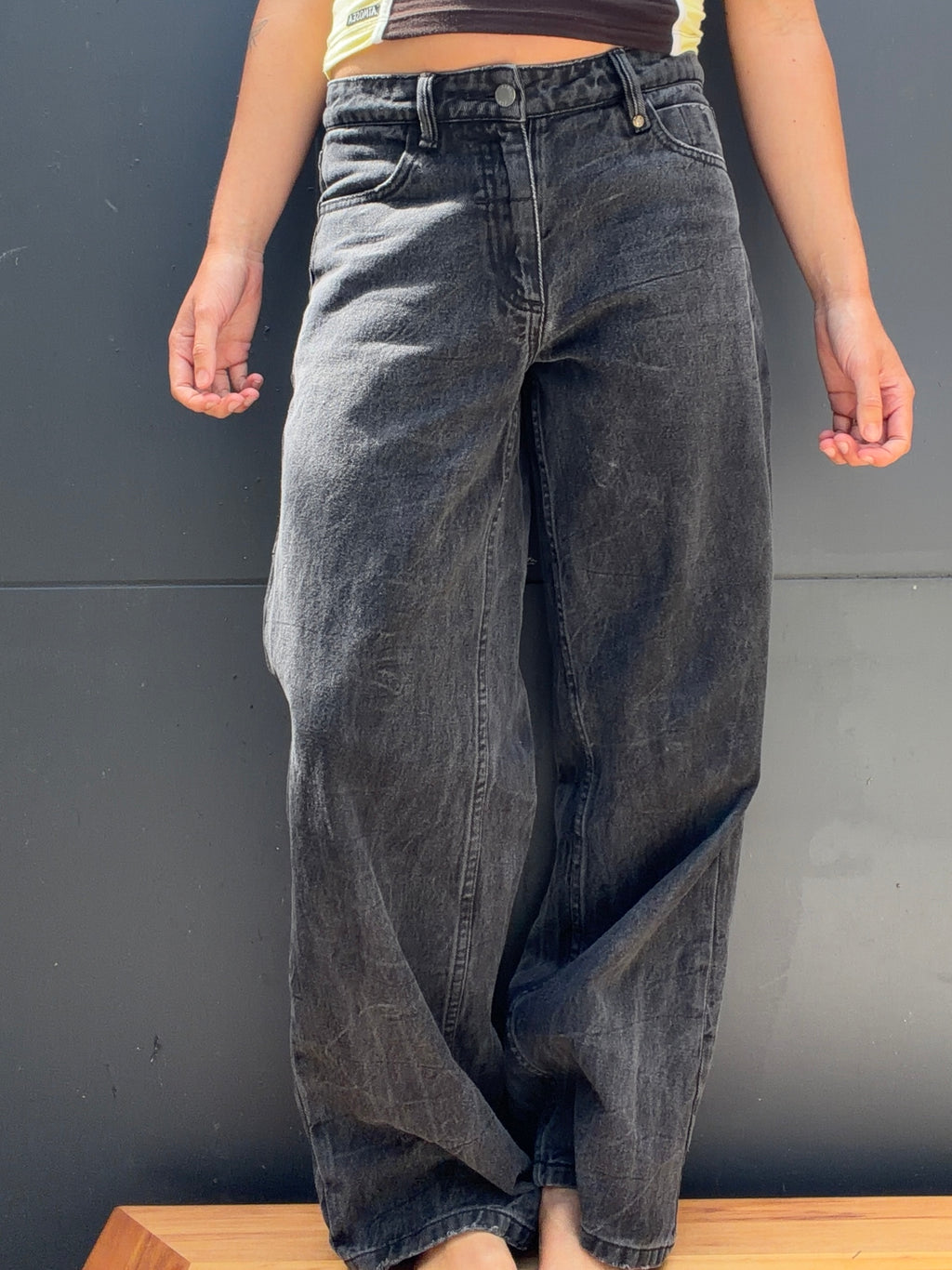 Side and rear view of THRILLS charcoal jeans showing back pocket and wide leg