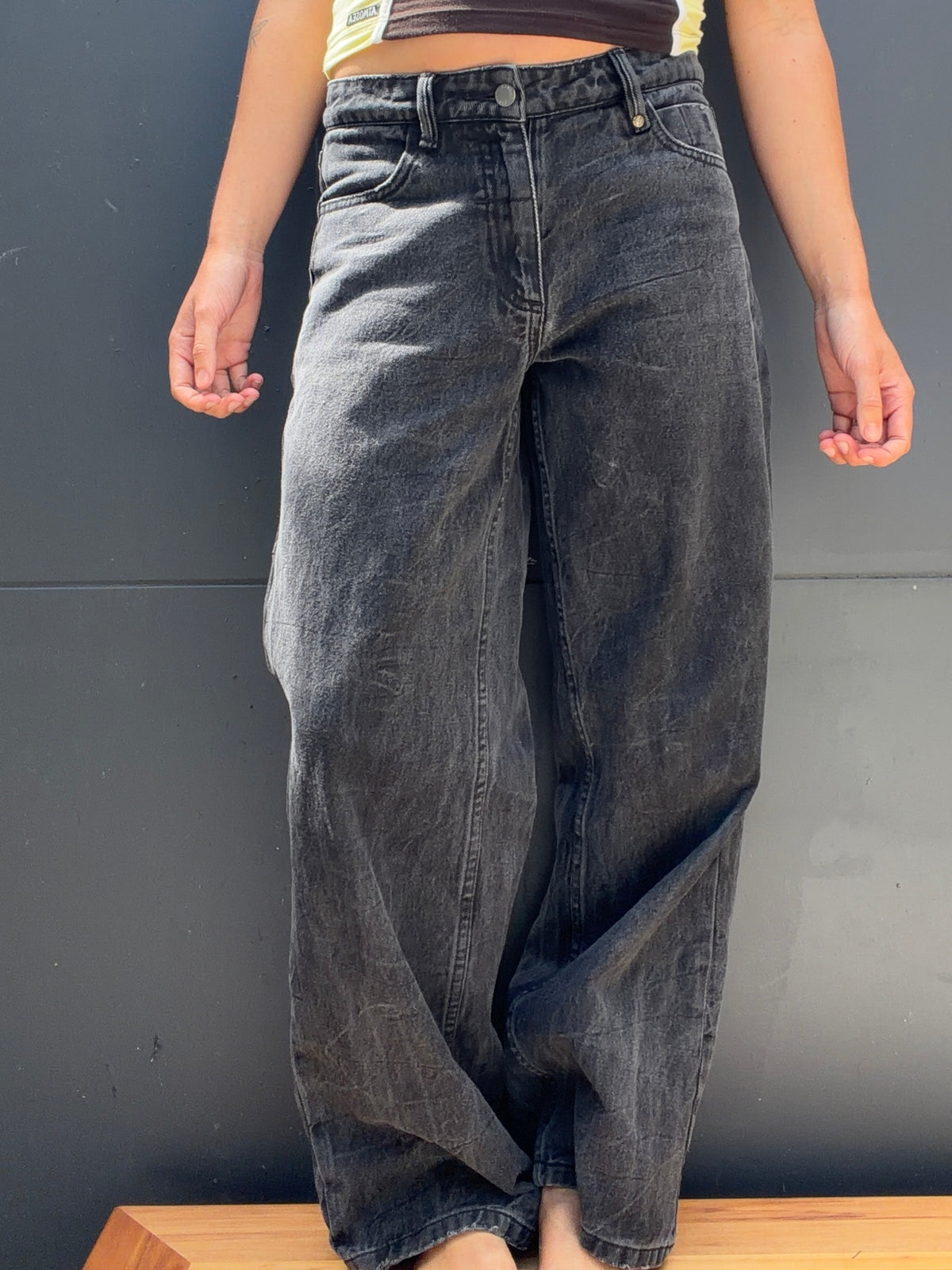 Side and rear view of THRILLS charcoal jeans showing back pocket and wide leg