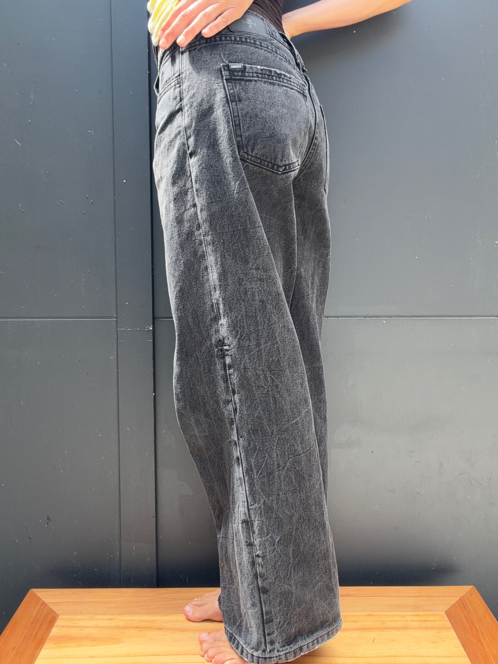 Front view of THRILLS washed charcoal wide-leg jeans, worn
