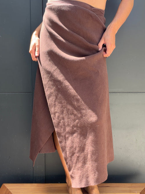Arcca Movement brown knit wrap skirt worn, showing overlapping front and asymmetric hem