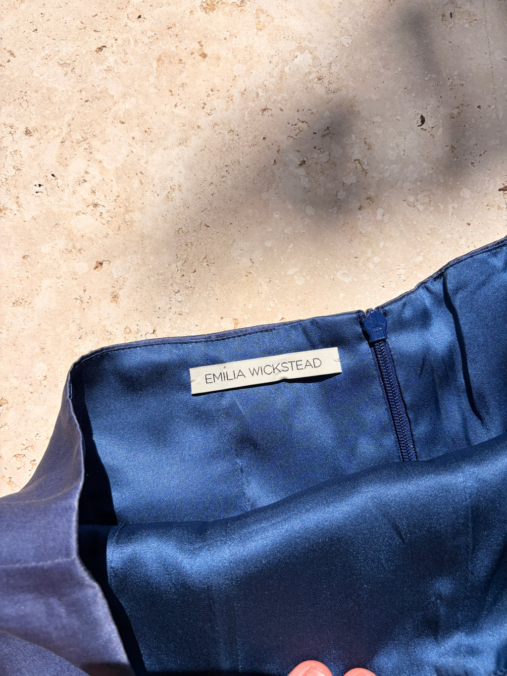 Close-up of structured blue skirt waistband and zip